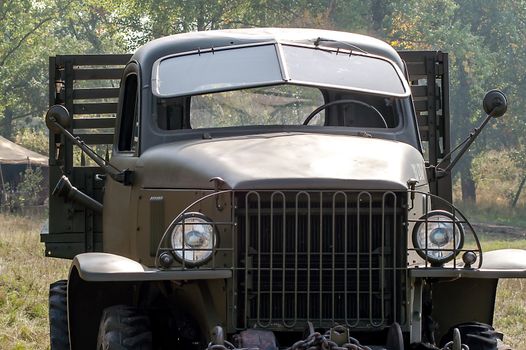 Gray and olive vintage military truck on the road