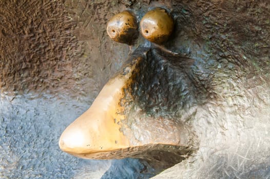 A person's nose and eyes closeup in the iron statue