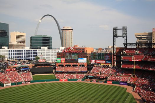 Fans gather for a late season Cardinals game at Busch Stadium, under the Gateway Arch.