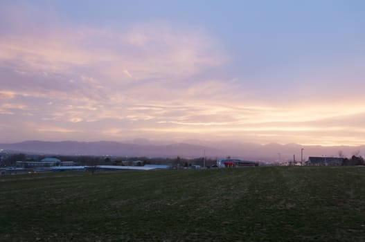 Purple and Blue sunset over an open farming field