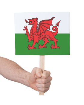 Hand holding small card, isolated on white - Flag of Wales
