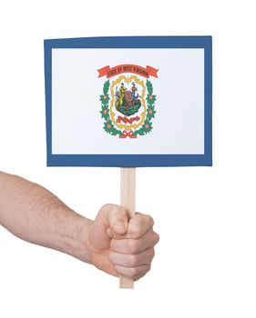 Hand holding small card, isolated on white - Flag of West Virginia