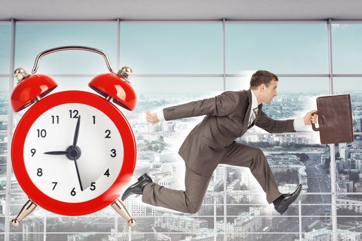 Businessman running on alarm clock backgound with interior view