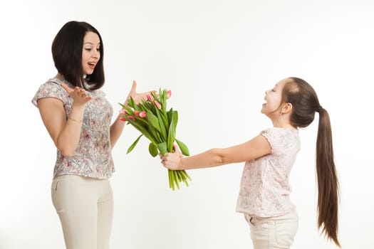 the girl gives to mother a bouquet of flowers