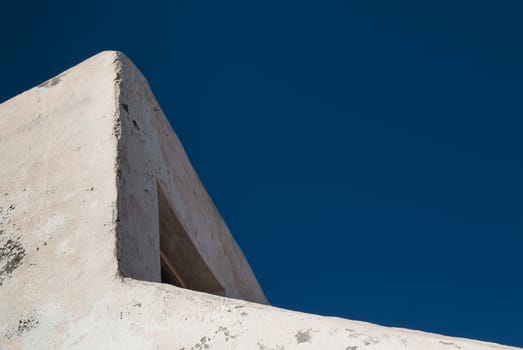 Detail of a traditional arabian architecture, enlightened by morning sun. Bright blue sky.