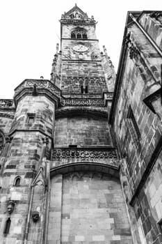 Bell tower of an ancient cathedral seen from below.