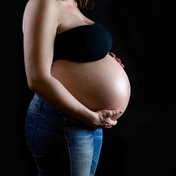 the sweet expectation of a pregnant on dark background