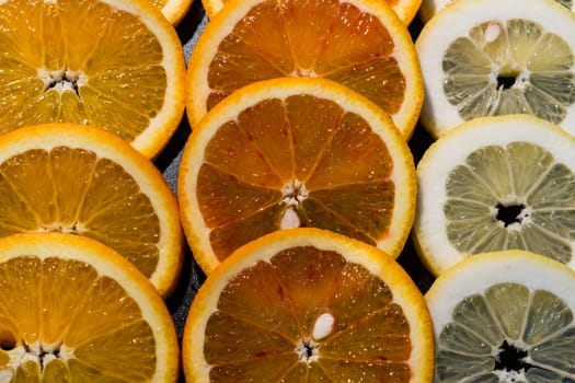 A variety of colorful fruit circles of oranges, limes, lemons and grapefruit for a background. Use it for a health or diet concept.