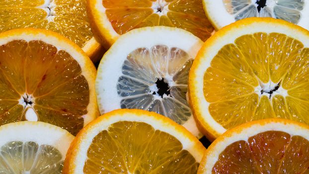 A variety of colorful fruit circles of oranges, limes, lemons and grapefruit for a background. Use it for a health or diet concept.