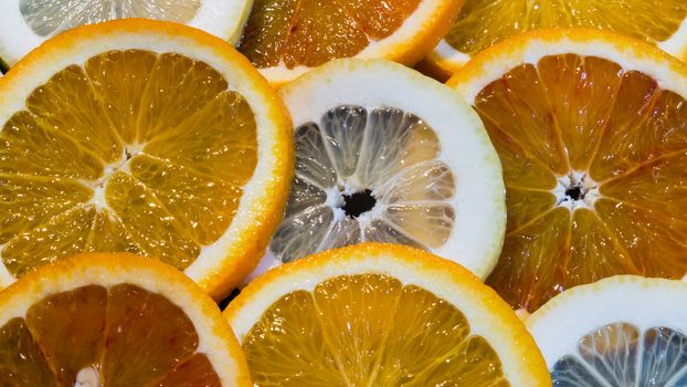 A variety of colorful fruit circles of oranges, limes, lemons and grapefruit for a background. Use it for a health or diet concept.