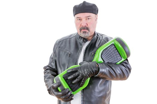 Rebellious middle aged man in leather jacket and gloves holding green and black hoverboard over white background