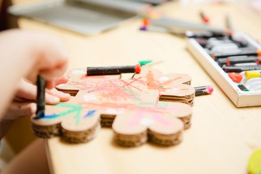 Little female baby painting with colorful paints. selective focus