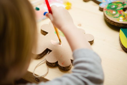 Little female baby painting with colorful paints. selective focus