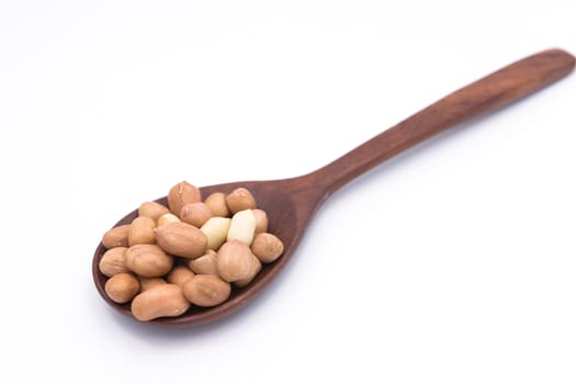 Peanut in wooden spoon on white background