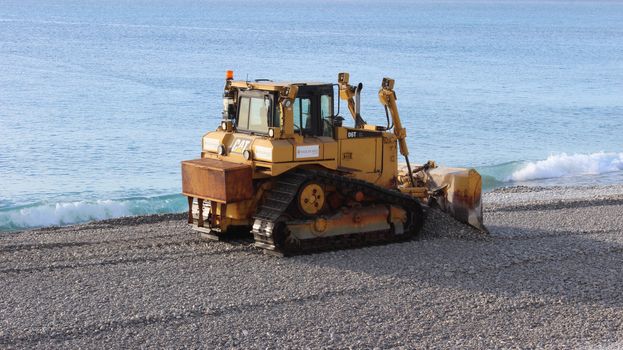 Nice, France - November 30 2015: Bulldozer D6T (Tier 4 Final) Caterpillar working on The Beach of Nice, France