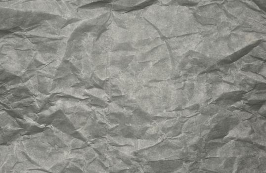 A sheet of clear creased parchment paper, interesting background and texture. Horizontal view.