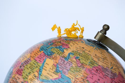 Plastic soldiers on top of a globe