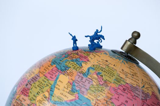 Plastic soldiers on top of a globe