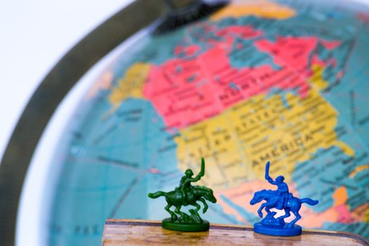 Plastic soldiers in front of a globe