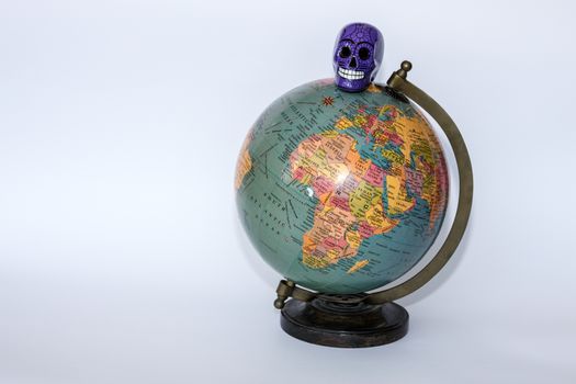 Porcelain skull on top of a globe