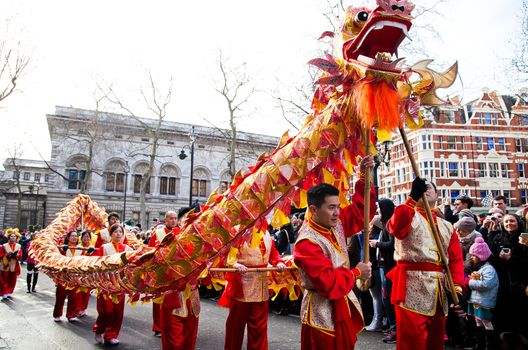 ENGLAND, London: People hold up a dragon float on February 14, 2016, during the Chinese New Year Parade in London. 