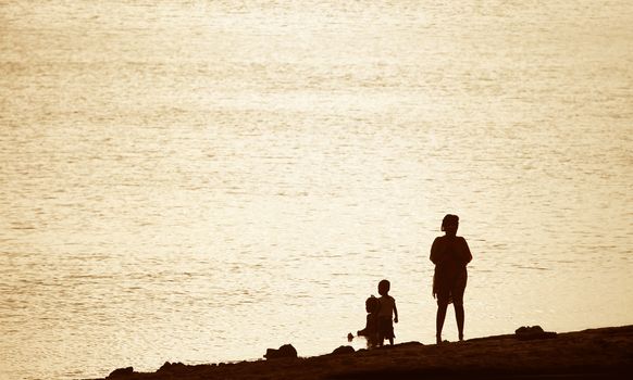 Stone Town, Zanzibar, Tanzania - January 2, 2016:  Family frolick in the surf in Stonetown, Zanzibar, Tanzania.