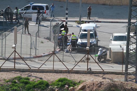 WARNING: GRAPHIC CONTENTWEST BANK:  Israeli defense forces stand at the scene, where a Palestinian man was killed on February 14, 2016, in the occupied West Bank near Har Homa.  The Palestinian was shot dead following a stabbing attempt against border police near a checkpoint.    