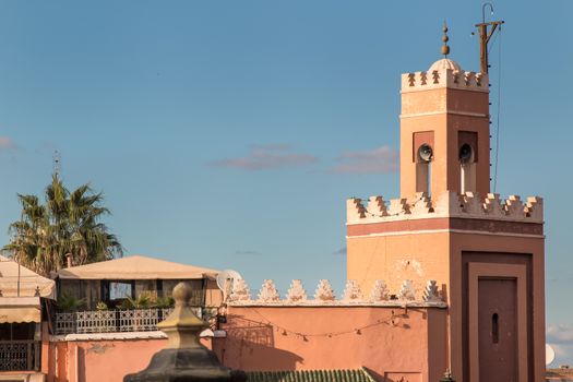 Minaret of a mosque in the coming sunset, located at the main square Jemaa el Fna.