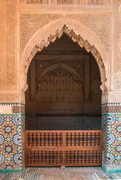 Mosaic, line with the arabian script and details of traditional stonework wall around the arch - entrance to the tombs.