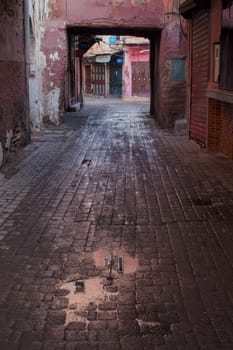 Street of old medina and souk, after a night rain. Early morning, before the crowd will come.