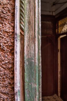 Part of the structured facade. Old frame of the door. Another doors in the background.