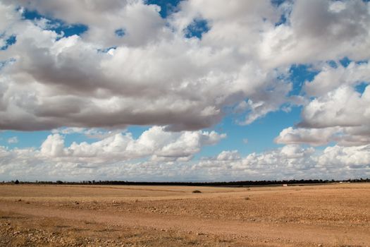 Moroccan nature in the autumn. Empty field ready for the new season. Intense cloudy sky.