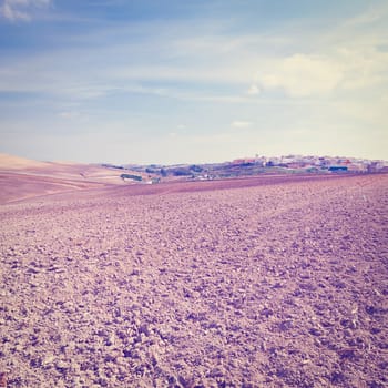 Plowed Field on the Background of the Small Spanish City, Instagram Effect