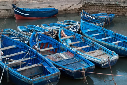 Blue small fishing boats in a port in Esaouira, Morocco.