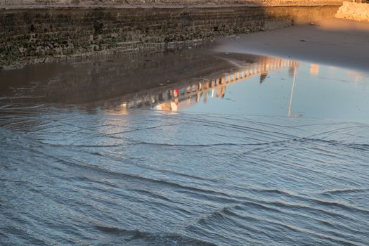 Reflection of the city in the water of the ocean.