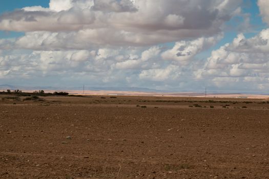 Moroccan nature in the autumn. Empty field ready for the new season. Intense cloudy sky.