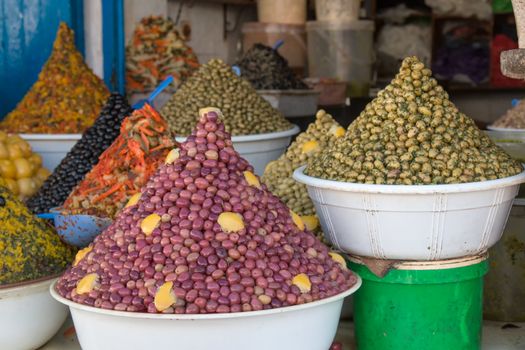 Pots with stylish decorated olives on the market in Morocco.