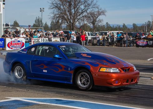 Redding, California: A Mustang Cobra spins its rear tires to heat them up for better traction at the drag strip.
Photo taken on: February 13th, 2016
