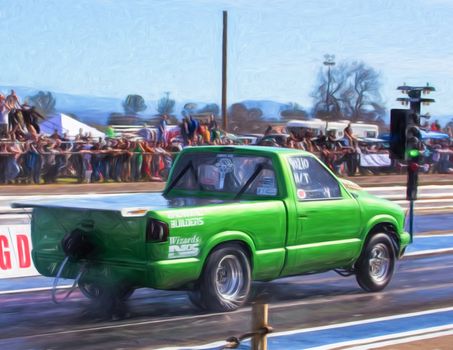 Redding, California: A small green pickup truck gets directions from a track official before the start of a drag race.
Photo taken on: February 13th, 2016