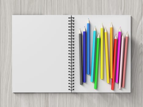 color pencil on checked notebook on wood background, stationary object