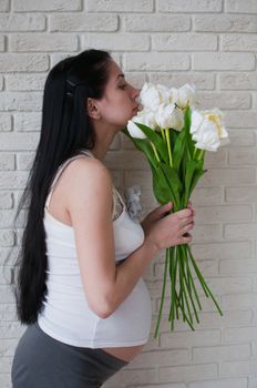 Portrait of the pregnant woman with flowers