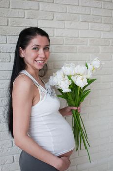 Portrait of the pregnant woman with flowers