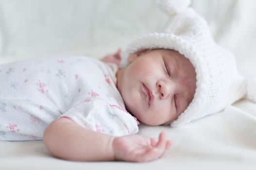 Portrait of the sleeping baby in hat