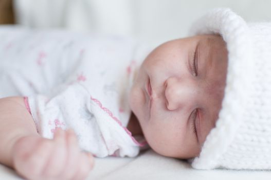 Portrait of the sleeping baby in hat