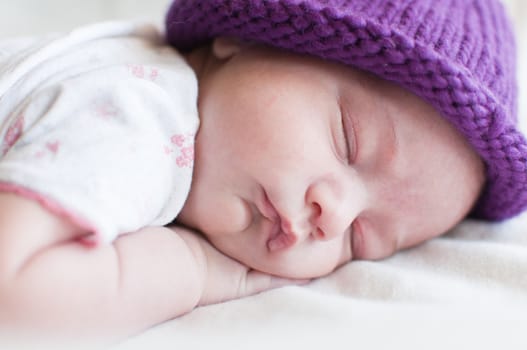 Portrait of the sleeping baby in hat