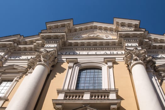 Detail of the architecture of Basilica di S. Carlo in Rome, Italy. Reflection of the blue sky in the window. Blue sky in the background.