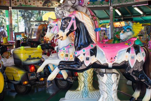 Nostalgic version of a traditional carousel with horses and other animals for fun of the children.