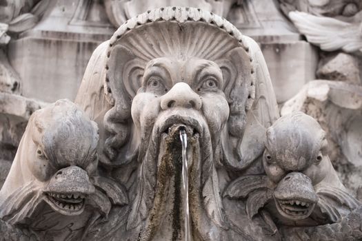 One of the roman beautiful fountains. This one is located in front of famous Pantheon. Baroque faces and fishes.