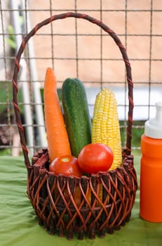 Group of colorful vegetables in a wicker basket.