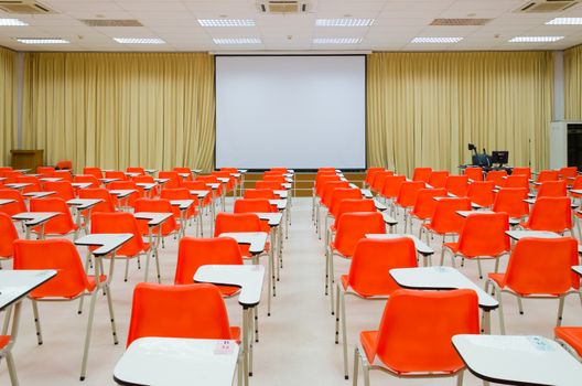 empty classroom, orange chairs and screen